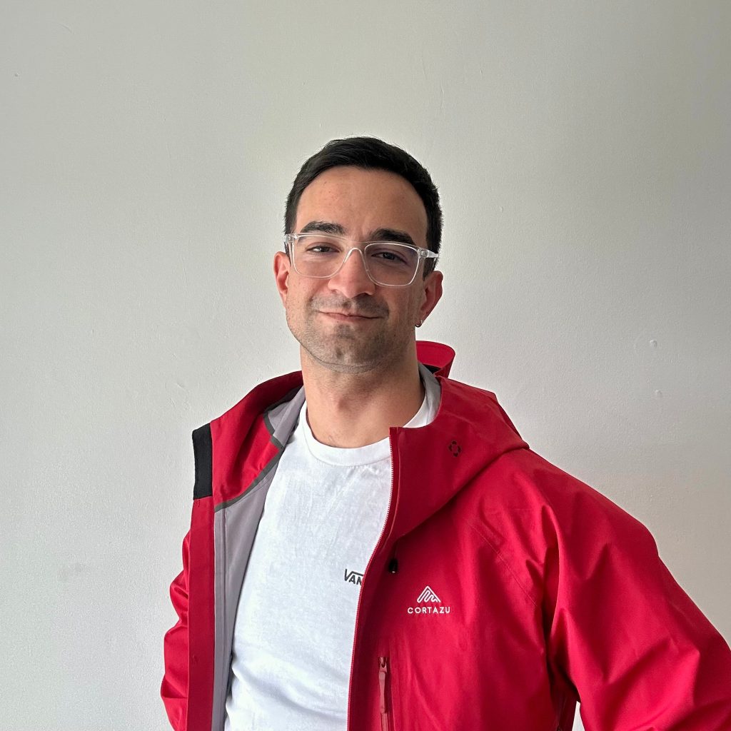 Ákos Hajdu, data and design professional, wearing a red jacket